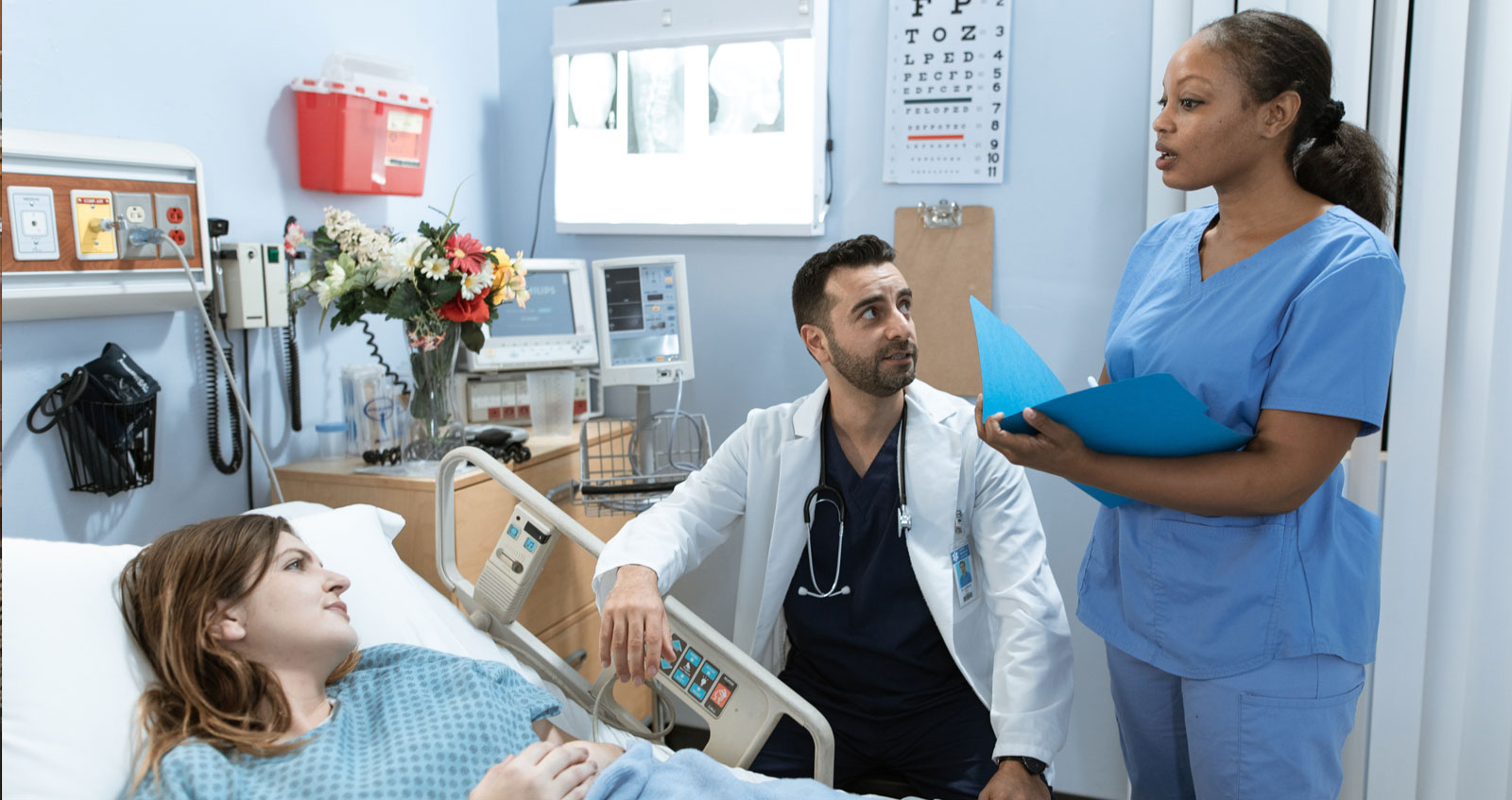 Doctors and staff in a hospital patient room